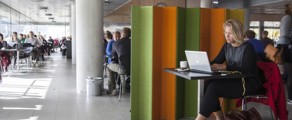 woman sitting in front of bright space divider